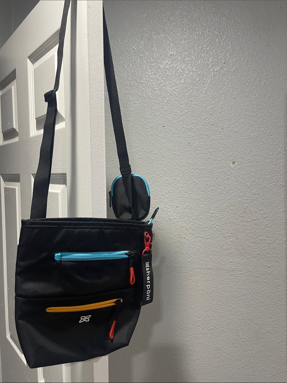 Sherpani Black Messenger Crossbody Bag with Blue and Yellow Accents